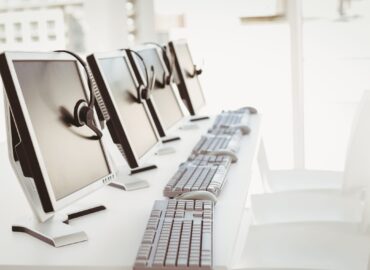 Call center computers and headsets all in a row